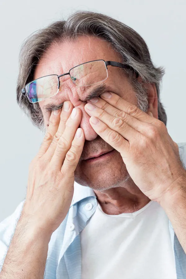 Chronic-Fatigue-Clinic-1 A middle-aged man pushes his glasses onto his forehead and rubs his eyes with exhaustion. Get chronic fatigue treatment from Thrive Family Practice & Med Spa in Statesboro.