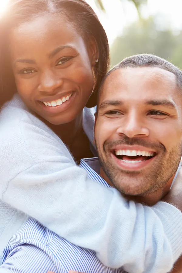Erectile-Dysfunction-Treatment A woman riding on a man's back, both smiling due to help with erectile dysfunction from Thrive Family Practice & Med Spa in Statesboro.