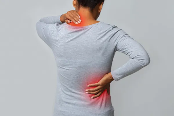 Fibromyalgia-Clinic An image from behind of a woman suffering from Fibromyalgia holding her hands on her neck and lower back. Get fibromyalgia care from Thrive Family Practice & Med Spa in Statesboro.