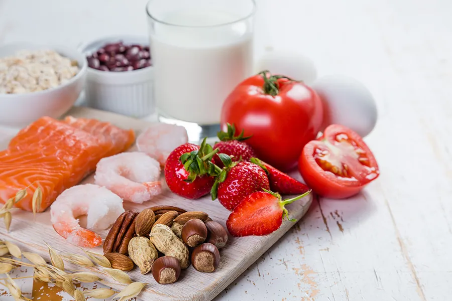A board of foods like nuts, shellfish, and dairy, that are commonly associated with allergies. Get treatment for food allergies from Thrive Family Practice & Med Spa in Statesboro.