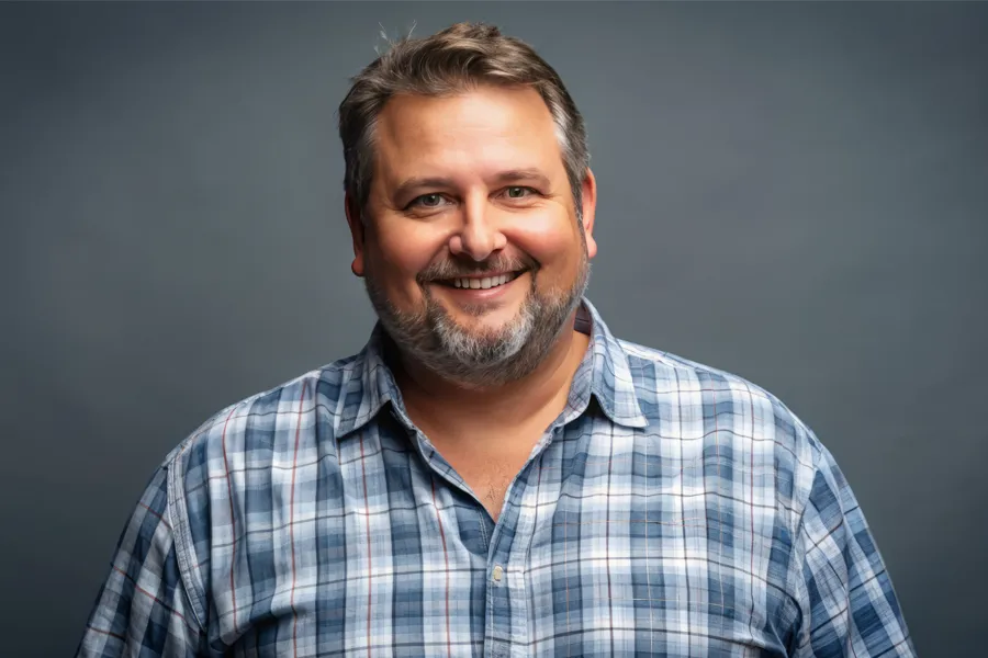 High-Cholesterol-Clinic A happy, slightly overweight man with a beard. Get treatment for high cholesterol from Thrive Family Practice & Med Spa in Statesboro.