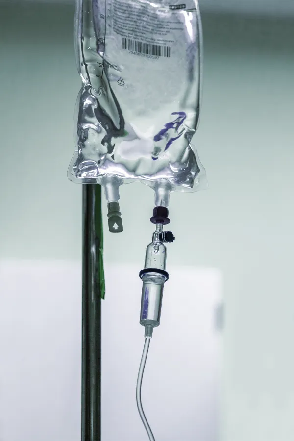 An IV bag with clear fluid hanging. Get IV nutrient therapy from Thrive Family Practice & Med Spa in Statesboro.