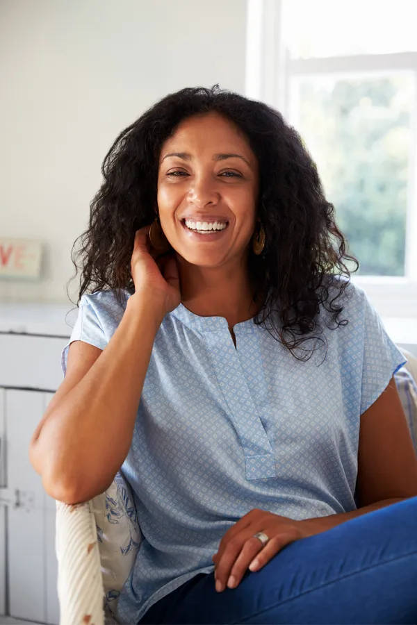 NuLift-Ultrasound-Facial-Therapy-Treatment A beautiful black woman with radiant skin sitting and smiling. Get a NuLift Ultrasound facial from Thrive Family Practice & Med Spa in Statesboro.