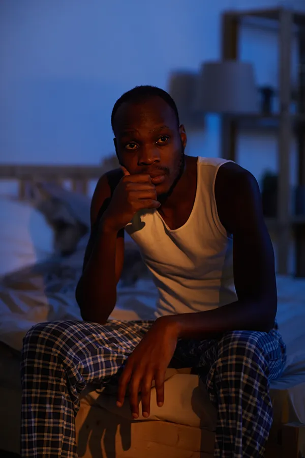 Sleep-Disorders-Treatment A man sits on the edge of his bed concerned that he can't sleep. Get treatment for sleep disorders from Thrive Family Practice & Med Spa in Statesboro.