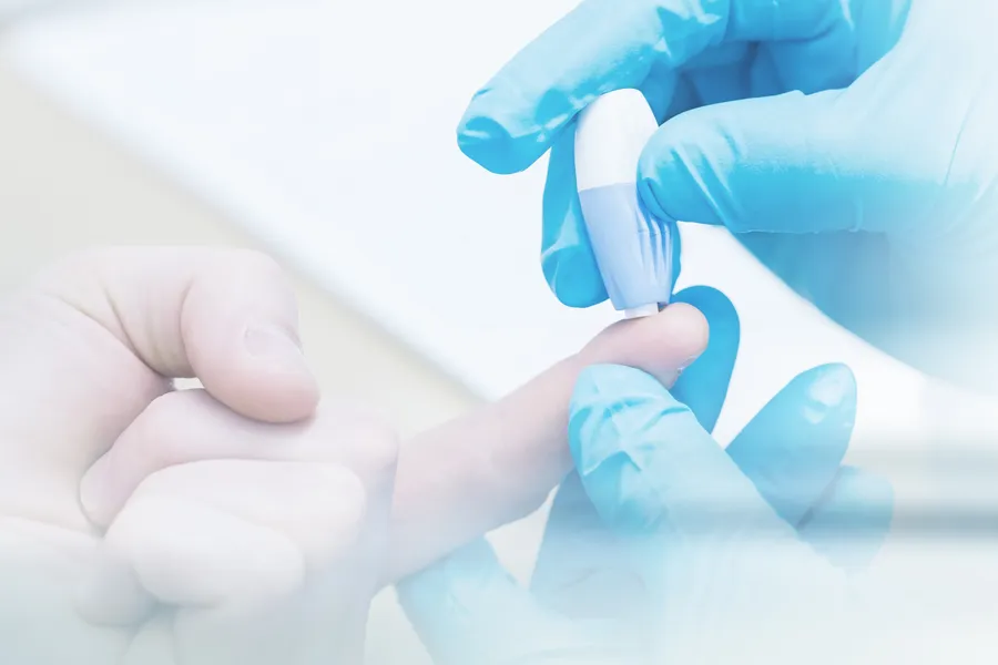 Type-2-Diabetes-Clinic Gloved hand performing a blood sugar check with a lancet. Thrive Family Practice & Med Spa offers expert Functional Medicine for Type 2 Diabetes care in Statesboro.