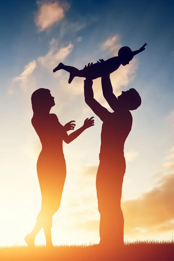 Whole-Family-Primary-Care-Treatment Silhouette of a happy family with a child lifted into the air in the sunset. Get Whole Family Primary Care from Thrive Family Practice & Med Spa in Statesboro.